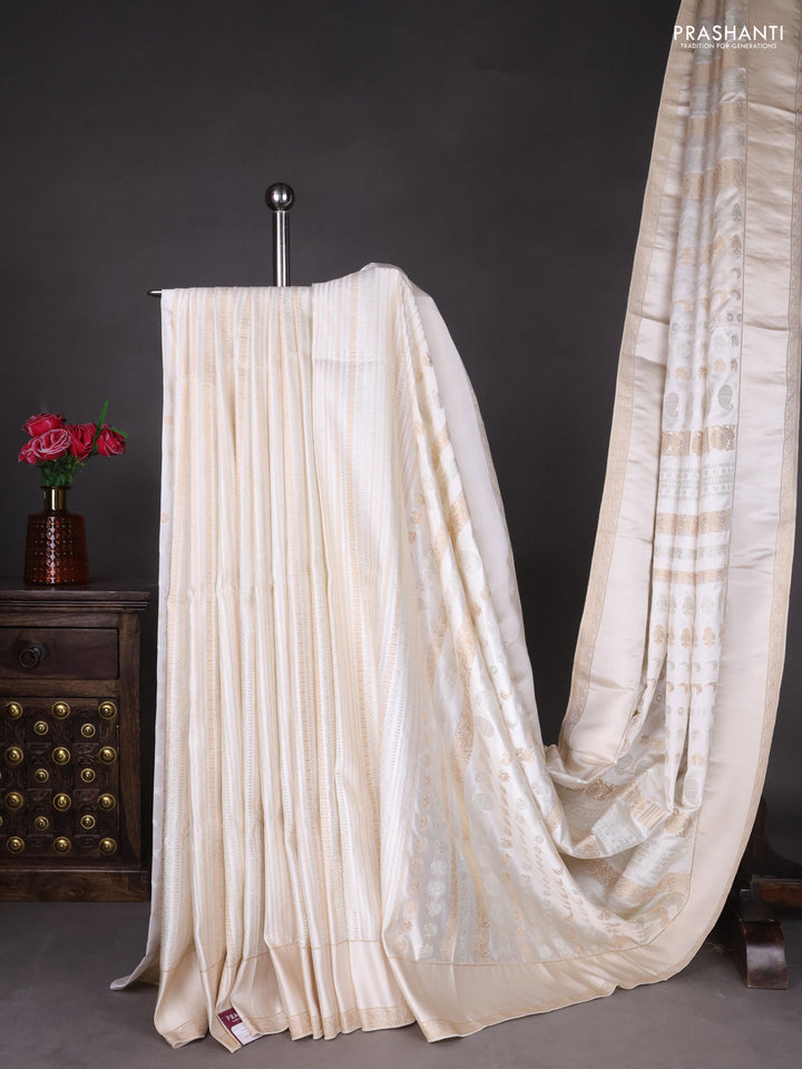 Semi kanchipuram partly saree off white with allover silver & zari weaves and rettapet zari woven border