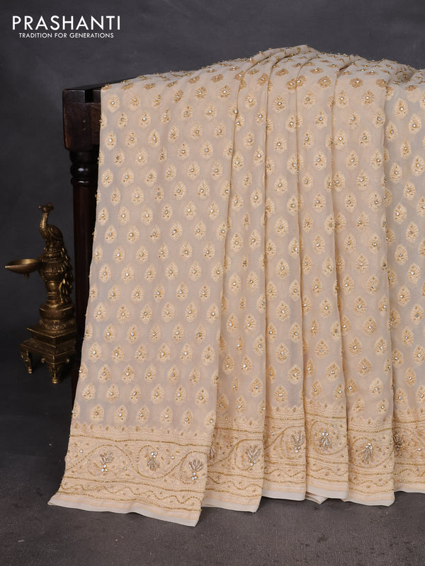 Banarasi georgette saree cream with woven buttas & stone work and zardosi work border
