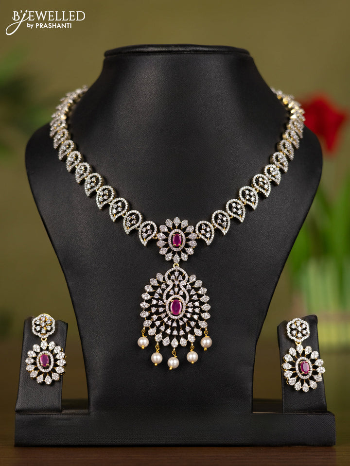 Zircon necklace manga pattern with ruby & cz stones and pearl hangings in gold finish