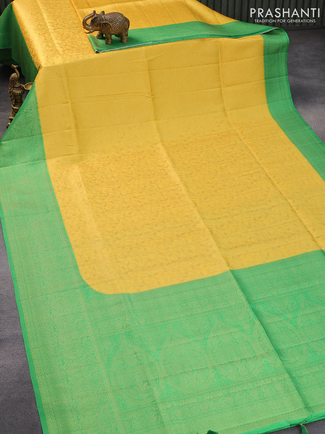 Banarasi softy silk saree yellow and green with allover silver zari woven brocade weaves and silver zari woven border