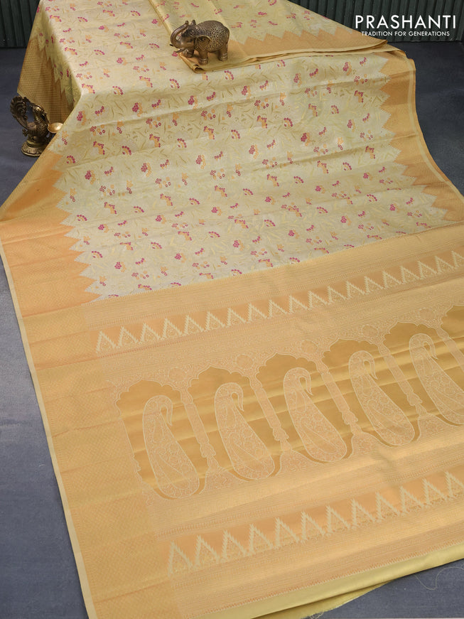 Tissue semi kanjivaram silk saree pale yellow with allover zari woven brocade weaves and temple design zari woven border