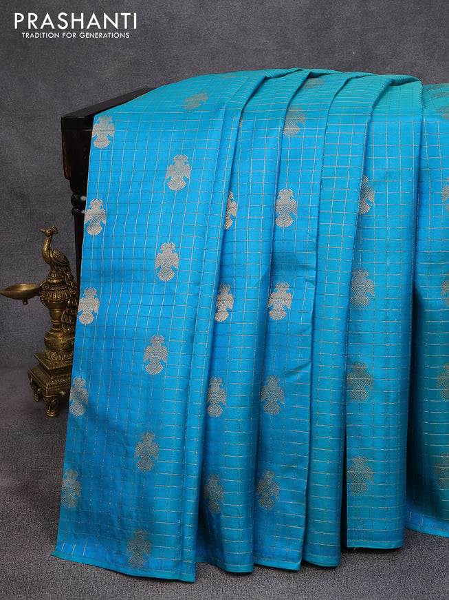 Pure kanjivaram silk saree dual shade of teal blue and dual shade of pinkish orange with allover zari checks & peacock buttas in borderless style