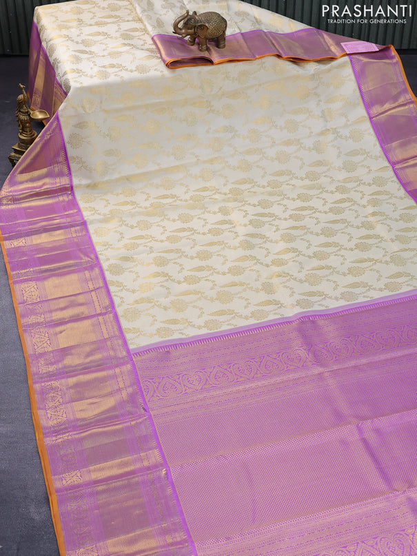 Pure kanjivaram silk saree cream and lavender shade with allover zari woven floral brocade weaves and long zari woven border
