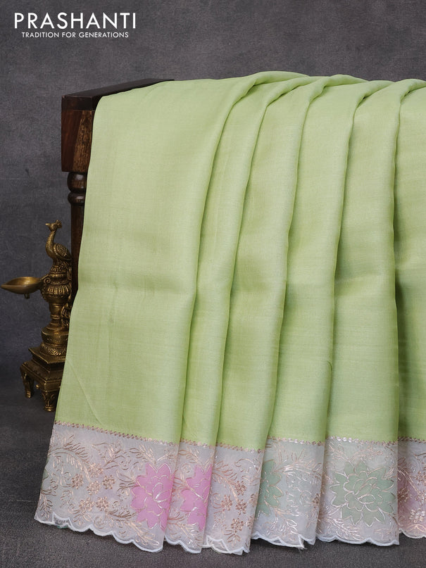 Pure tussar silk saree pista green and off white with plain body and organza embroidery work border