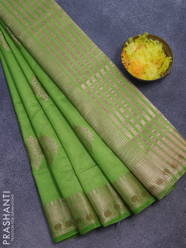 Semi raw silk saree green with floral zari woven buttas and zari woven border