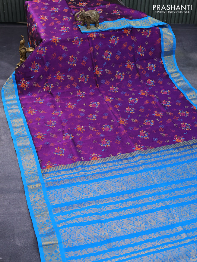 Silk cotton saree purple and cs blue with allover floral prints and zari woven korvai border