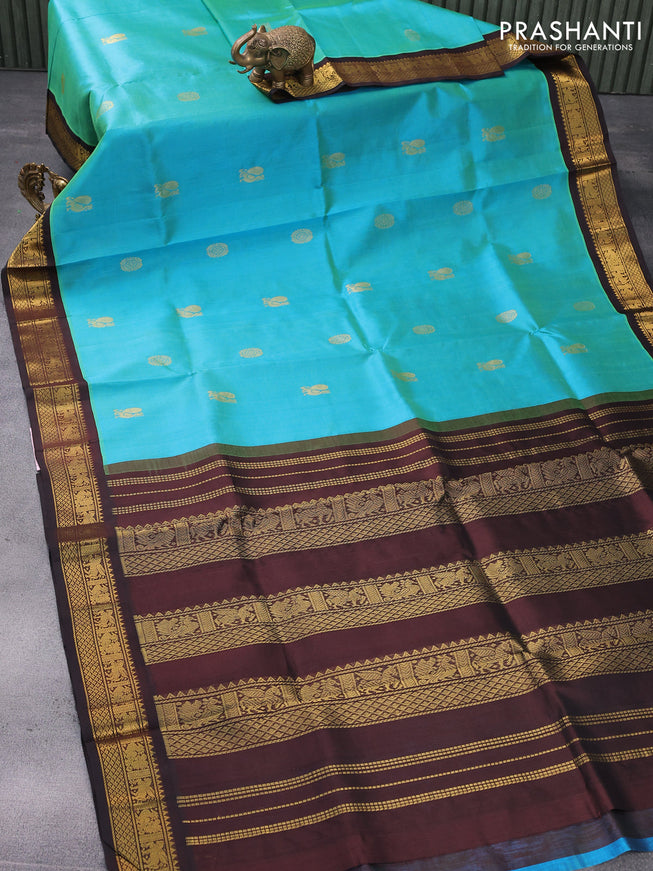 Silk cotton saree dual shade of bluish green and brown with annam & rudhraksha zari woven buttas and zari woven korvai border
