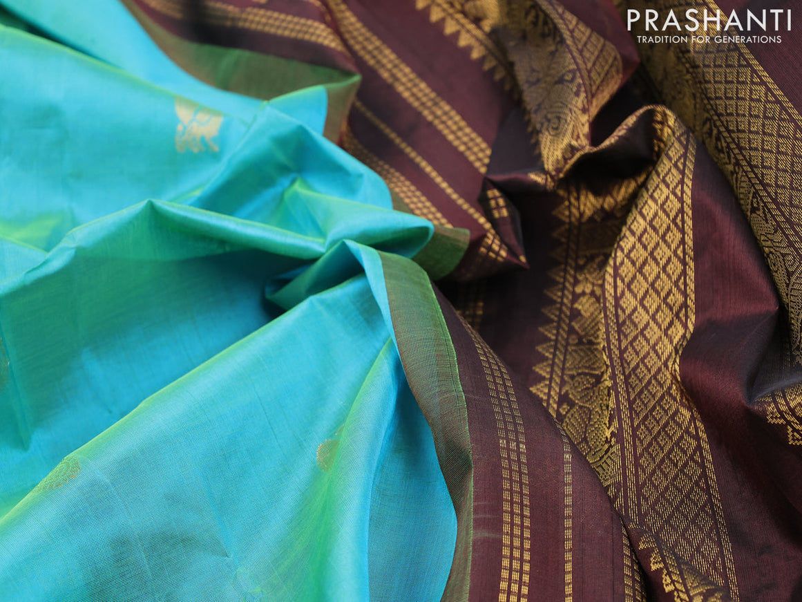 Silk cotton saree dual shade of bluish green and brown with annam & rudhraksha zari woven buttas and zari woven korvai border