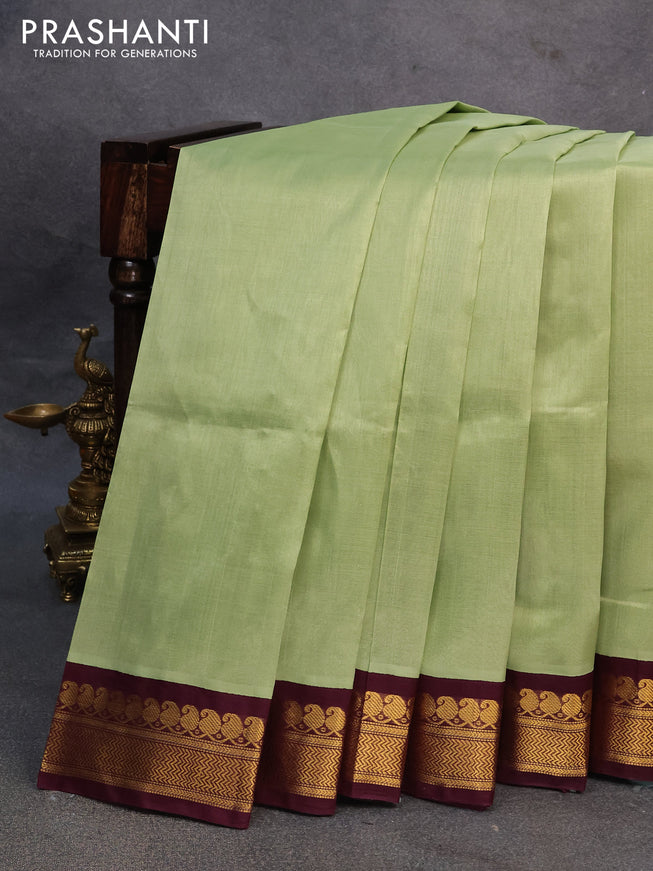 Silk cotton saree pista green and wine shade with plain body and zari woven korvai border