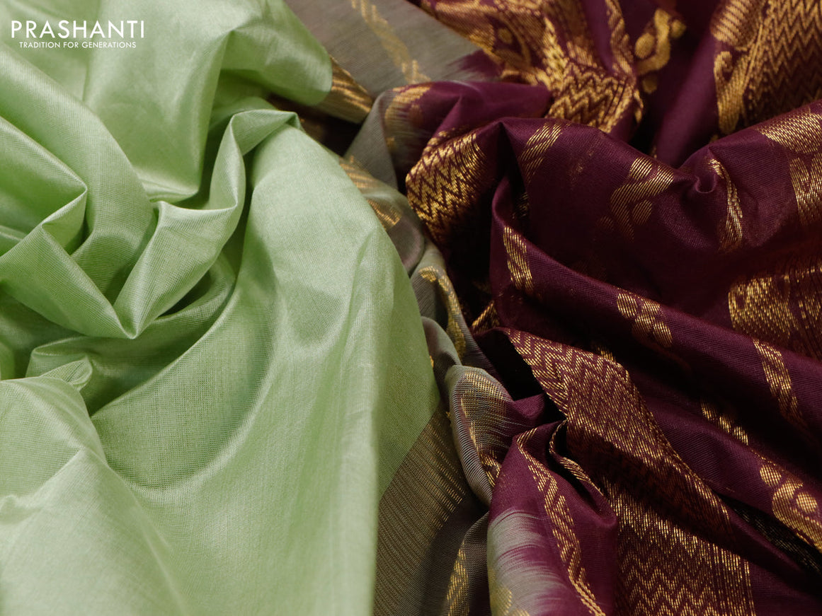Silk cotton saree pista green and wine shade with plain body and zari woven korvai border
