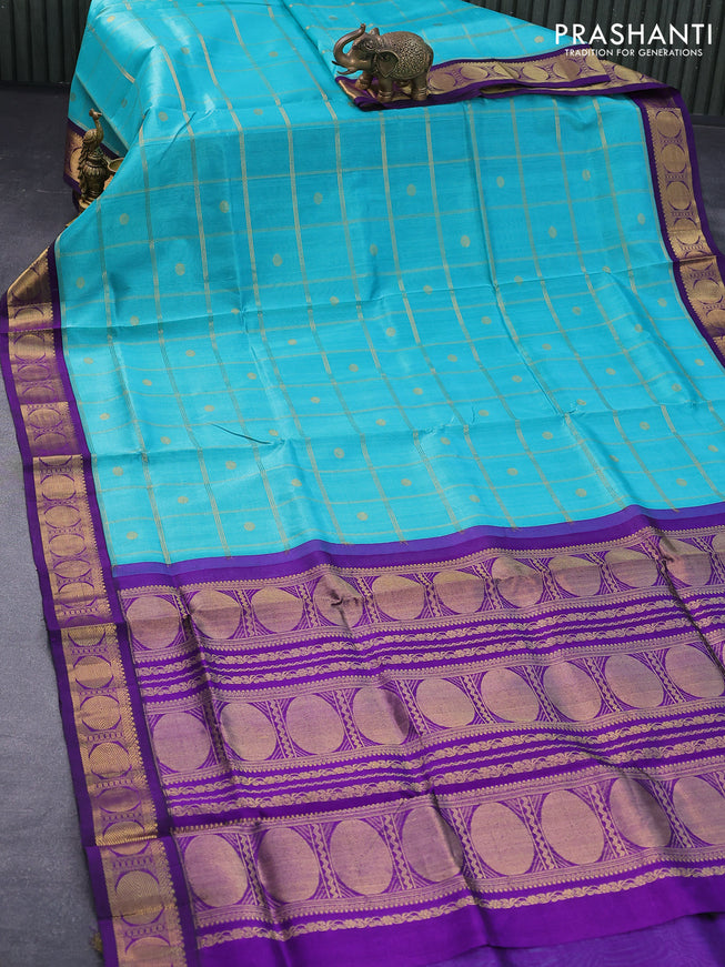 Silk cotton saree teal blue and violet with allover zari checks & buttas and rudhraksha zari woven korvai border
