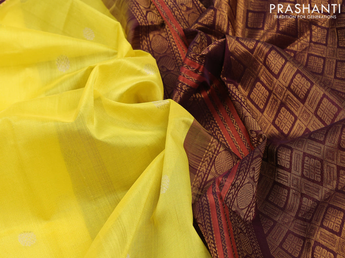 Silk cotton saree yellow and coffee brown with silver zari woven buttas and zari woven korvai border