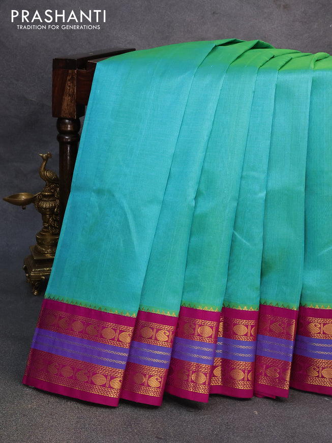 Silk cotton saree dual shade of teal bluish green and purple with plain body and zari woven korvai border
