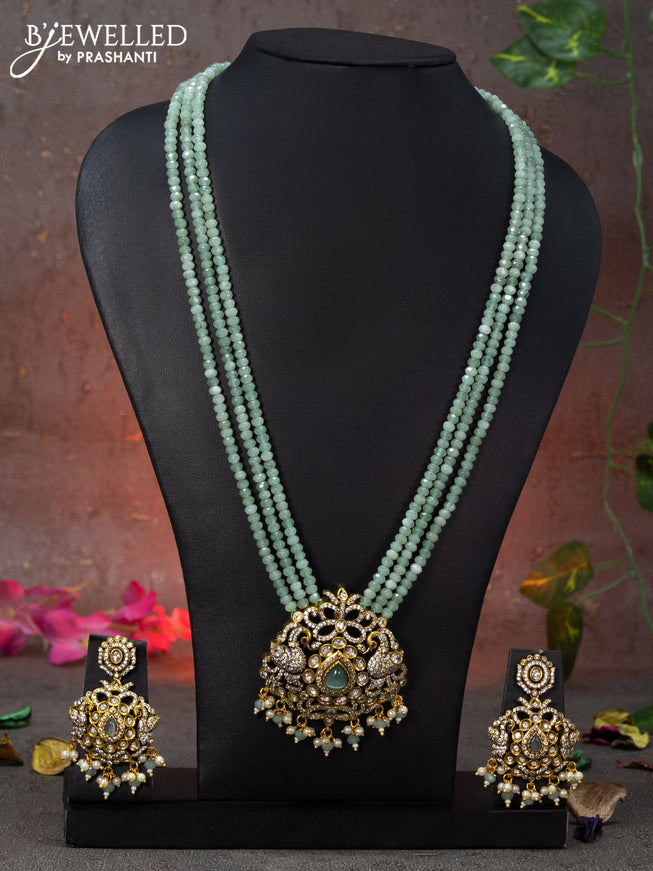 Beaded triple layer mint green necklace peacock design with cz stones and beads hanging in victorian finish