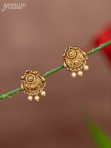 Antique earring chandbali deisgn in gold with red and green stones and pearl hanging