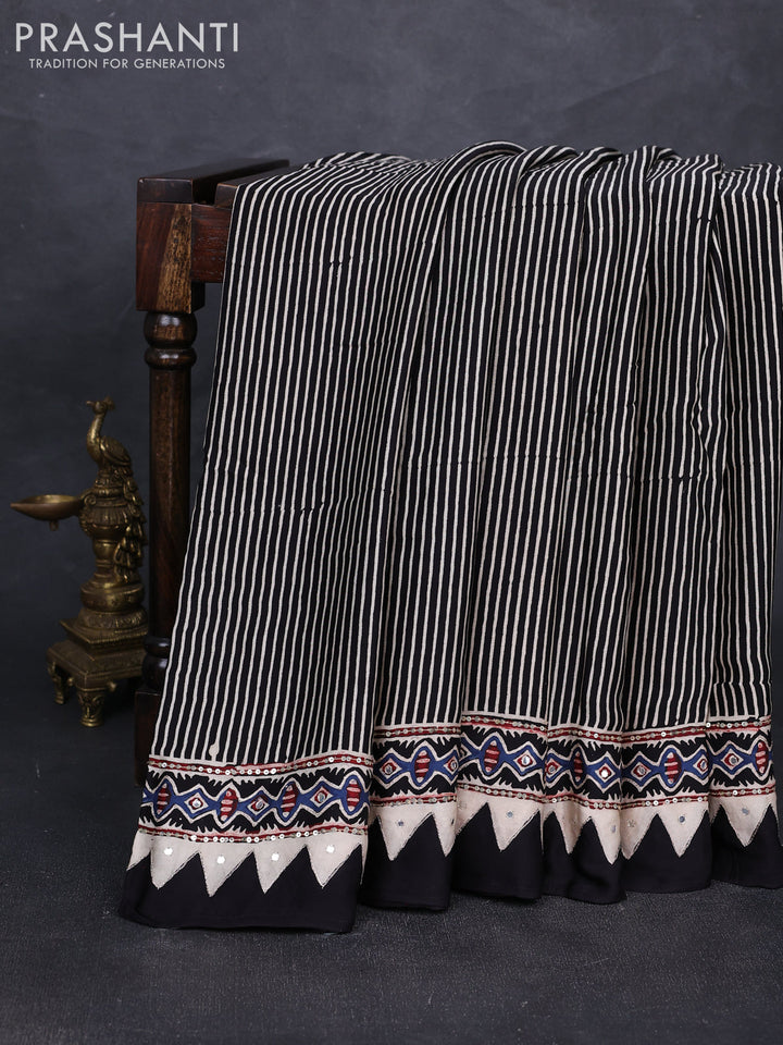 Modal silk saree black with allover stripe prints and ajrakh prints mirror & sequin embroidery pallu
