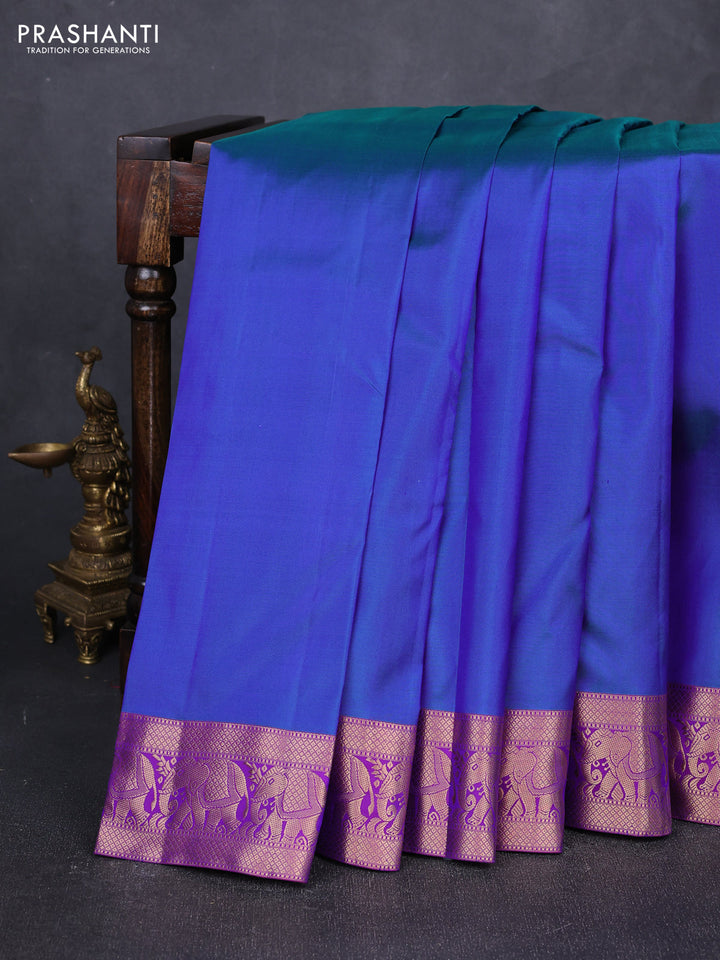 Pure kanchipuram silk saree dual shade of bluish green and purple with plain body and rich zari woven elephnat border