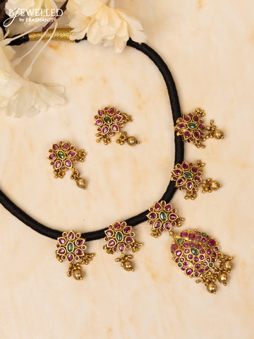 Black thread necklace with kemp stones and golden beads hangings