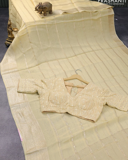 Organza silk saree pale yellow with allover zari woven stripes pattern and zari woven border & embroidery work readymade blouse