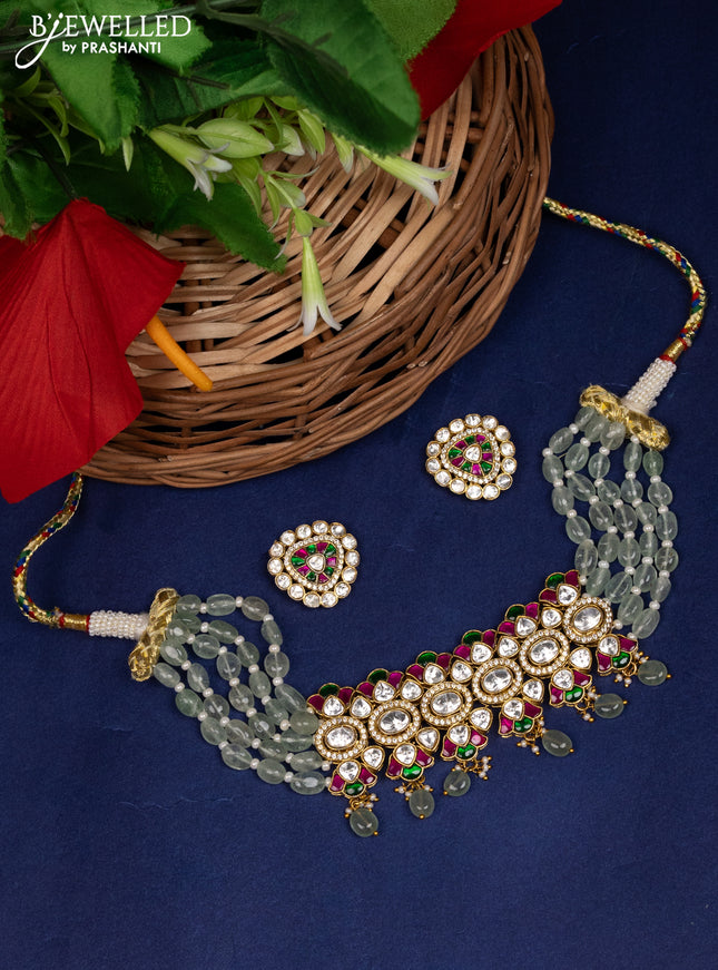 Antique choker with red ,green and white kundan stones and pearl drops
