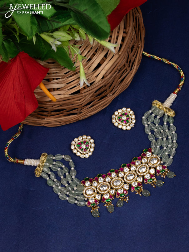 Beaded choker with red ,green and white kundan stones and pearl drops