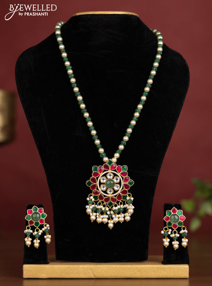 Antique beaded green and pearl necklace with a floral pendant, jadau kundan stones, and pearl & bead hangings