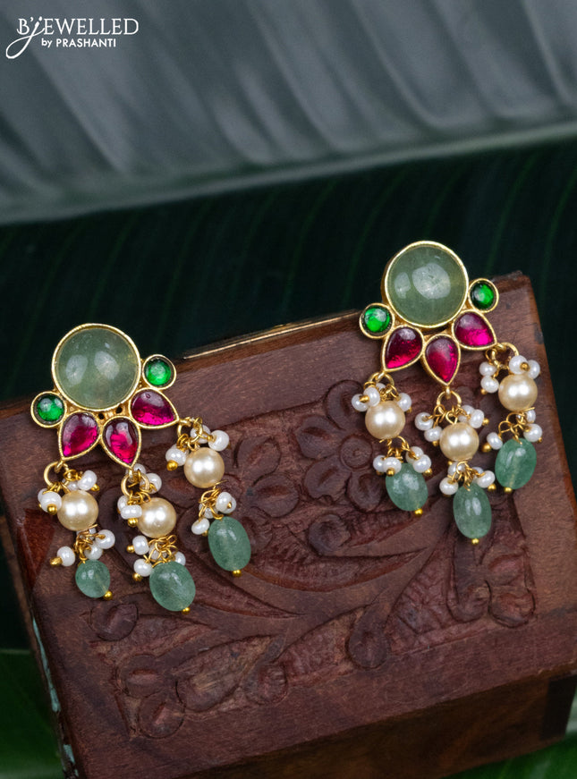 Jadau screw type earrings with jadau kundan stones and pearl & mint green beads hanging