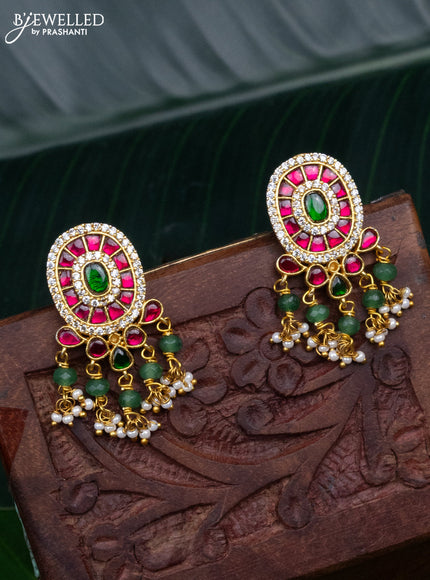 Jadau screw type earrings with jadau & cz stones and pearl & green beads hanging