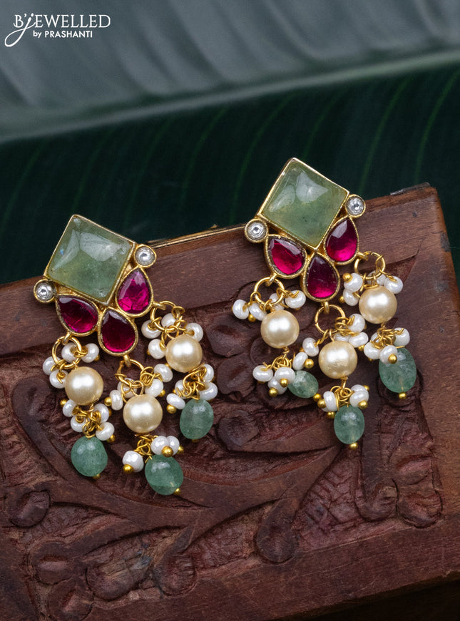 Jadau screw type earrings with jadau kundan stones and pearl & mint green beads hanging