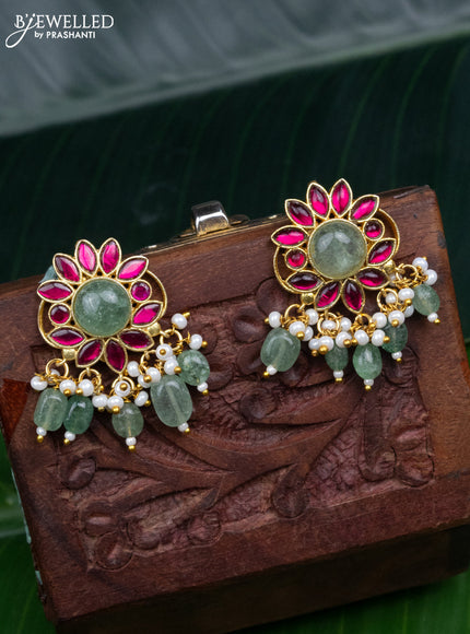 Jadau screw type earrings with pink jadau stones and pearl & mint green beads hanging