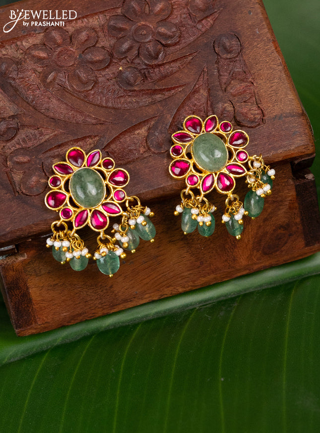 Jadau screw type earrings with pink jadau stones and pearl & green beads hanging