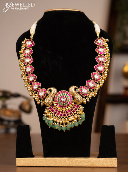 Antique necklace peacock design with jadau kundan stones and green & golden beads hanging without earrings