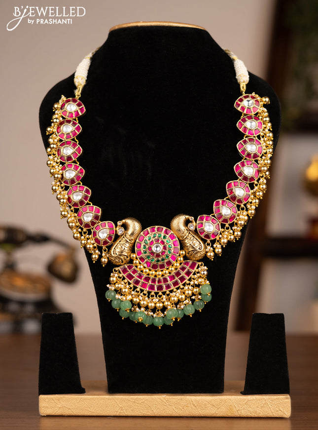 Antique necklace peacock design with jadau kundan stones and green & golden beads hanging without earrings