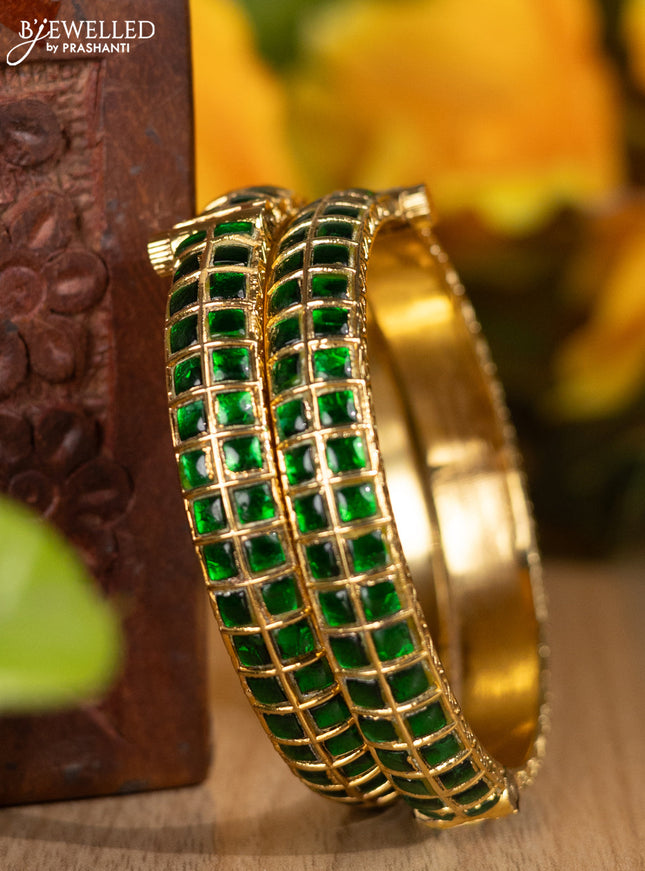 Jadau screw type bangles with green jadau stones