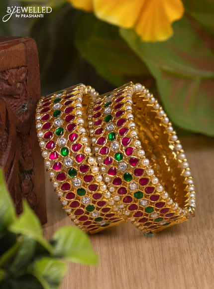 Jadau screw type bangles with jadau kemp kundan stones and pearls