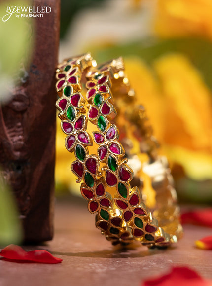 Jadau screw type bangle with floral design and jadau kemp stones