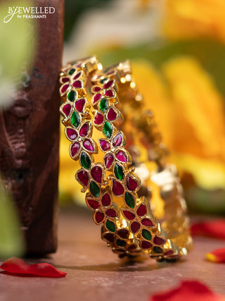 Jadau screw type bangle with floral design and jadau kemp stones