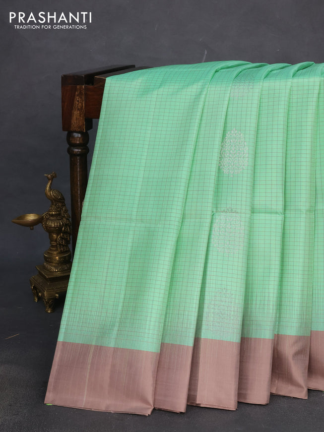 Pure soft silk saree teal green shade and pastel brown with allover checks & silver zari woven buttas and simple border