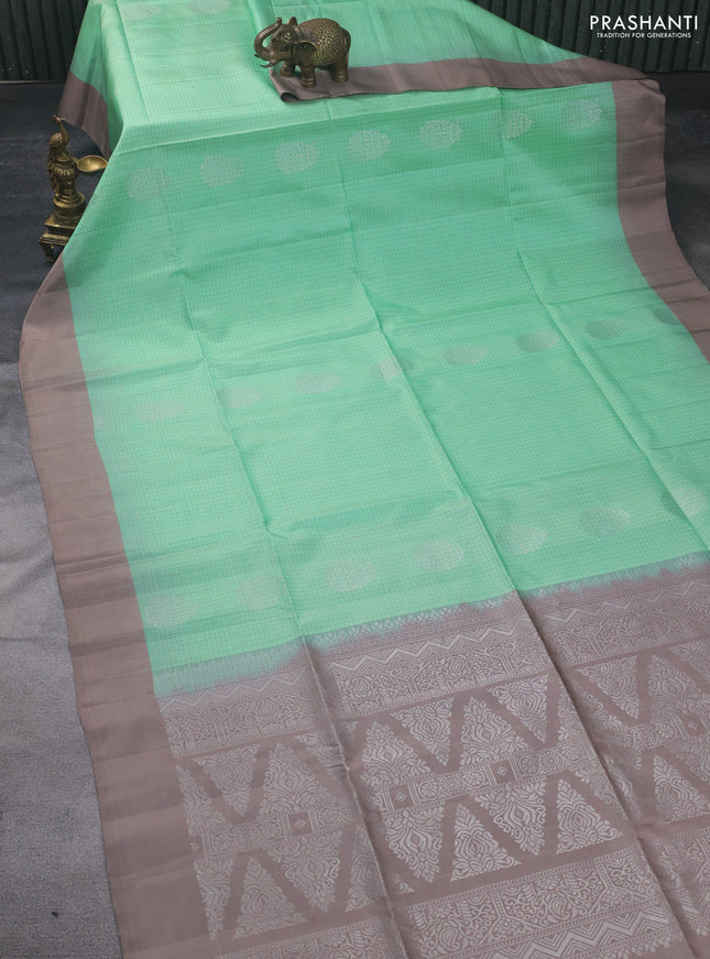 Pure soft silk saree teal green shade and pastel brown with allover checks & silver zari woven buttas and simple border