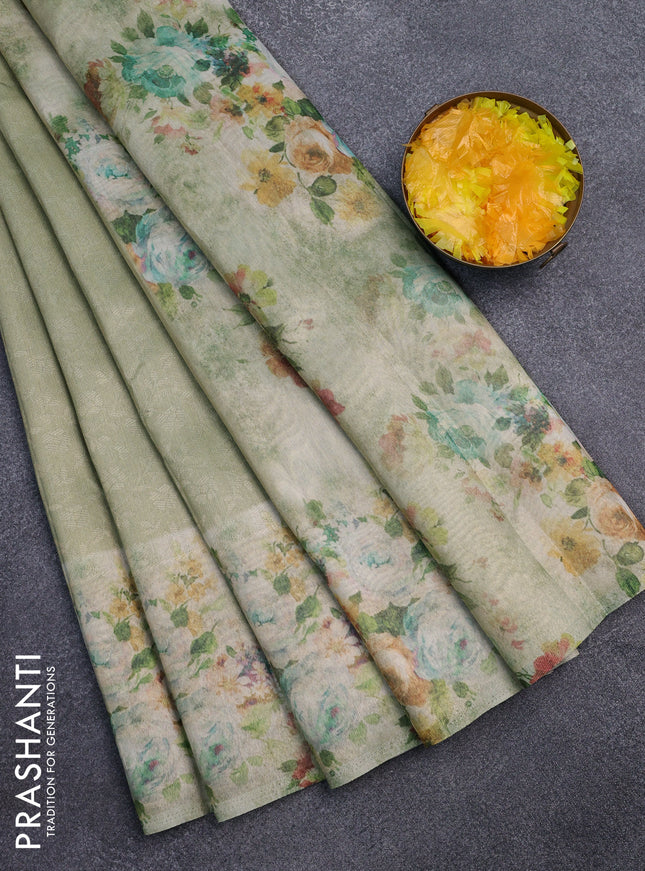 Tissue saree mild pista green with allover zari weaves and floral digital printed border