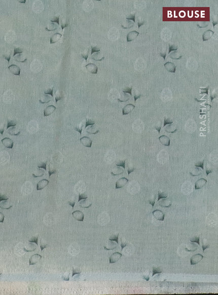 Tissue saree pastel blue with allover zari weaves and floral digital printed border