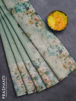 Tissue saree teal green shade with allover zari weaves and floral digital printed border