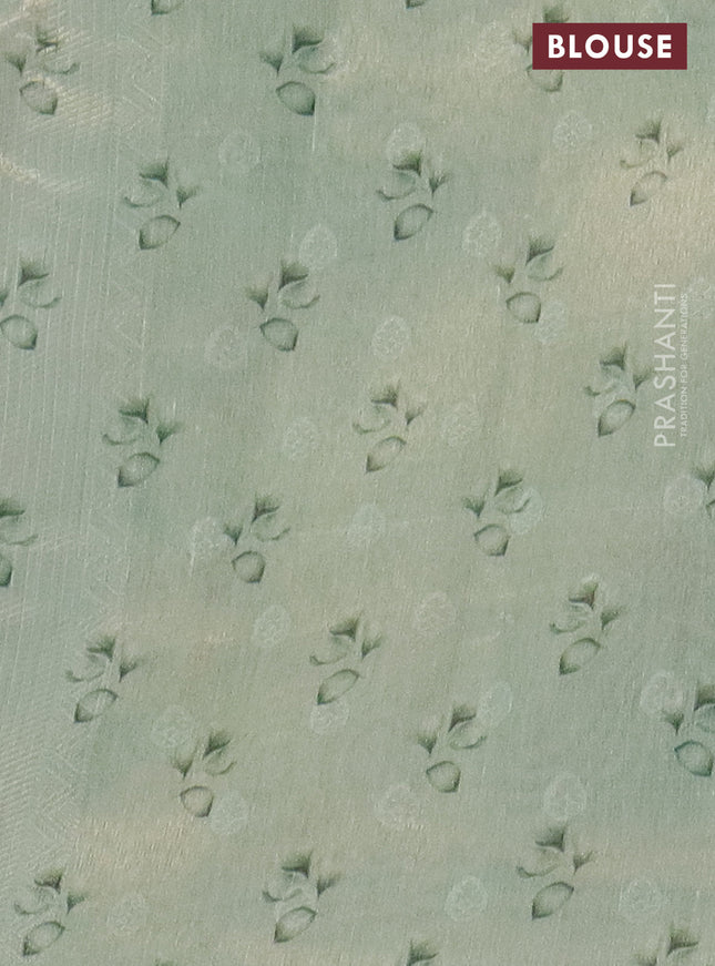 Tissue saree teal green shade with allover zari weaves and floral digital printed border