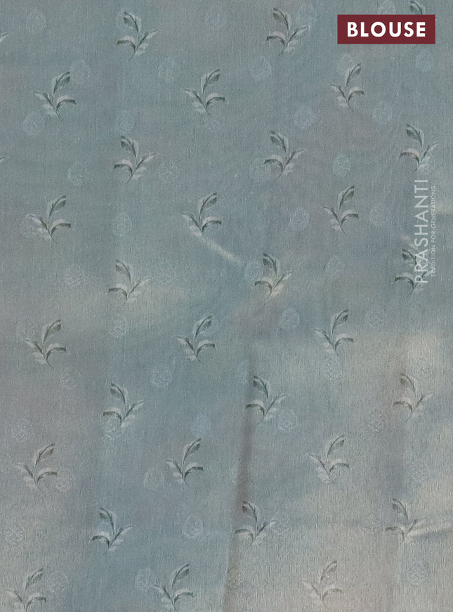 Tissue saree pista green and light blue with allover zari weaves and floral digital printed border