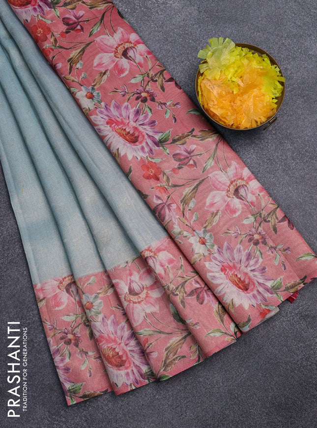 Tissue saree light blue and peach pink with allover zari weaves and floral digital printed border