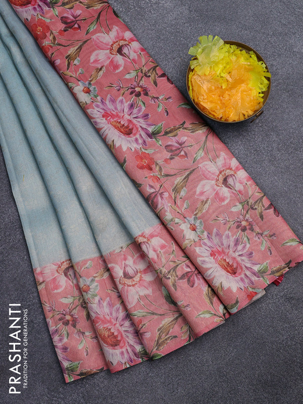 Tissue saree light blue and peach pink with allover zari weaves and floral digital printed border