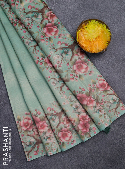 Tissue saree teal green shade with allover zari weaves and floral digital printed border
