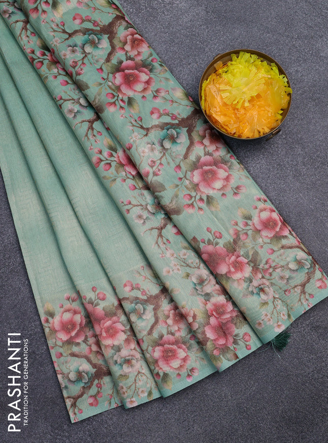 Tissue saree teal green shade with allover zari weaves and floral digital printed border
