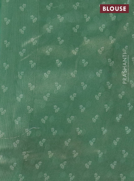 Tissue saree teal green shade with allover zari weaves and floral digital printed border