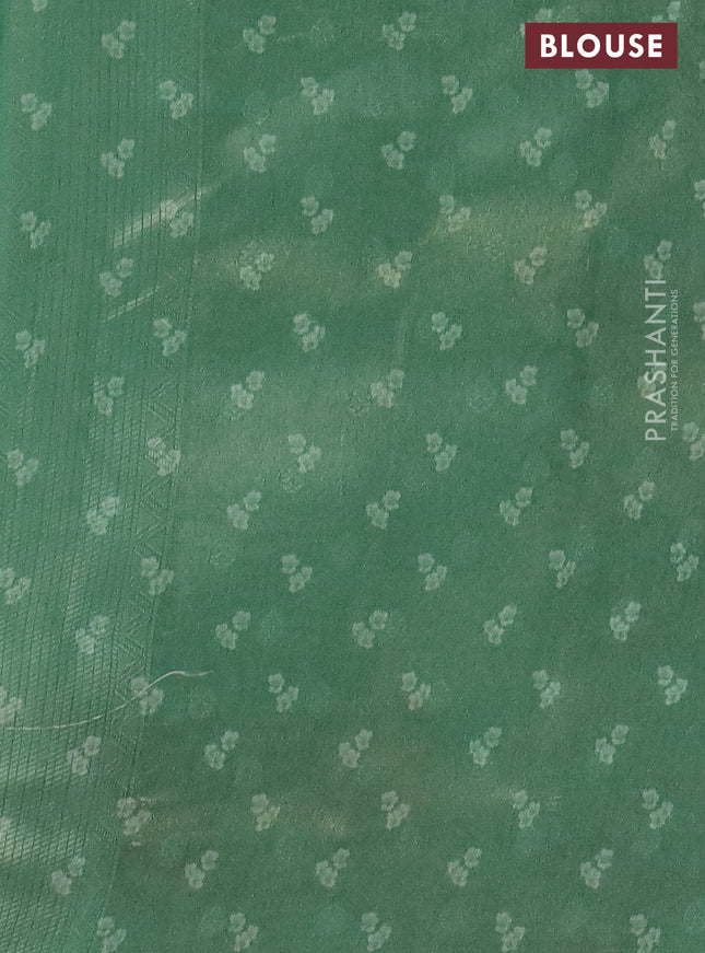 Tissue saree teal green shade with allover zari weaves and floral digital printed border